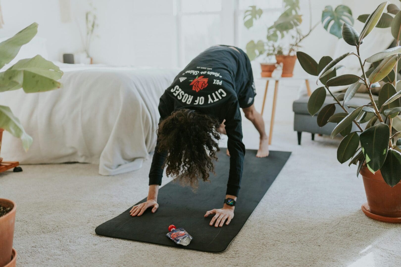 A person doing yoga on the floor in their living room.